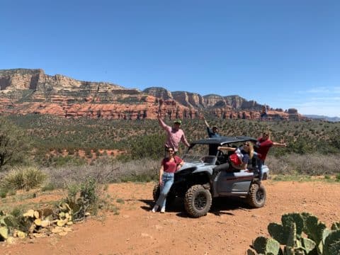 Tourist posing on 4-seater atv rental off roading in Sedona Arizona