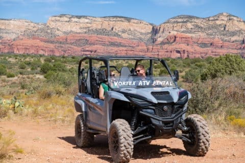 Friends enjoying views inside a off-road rental